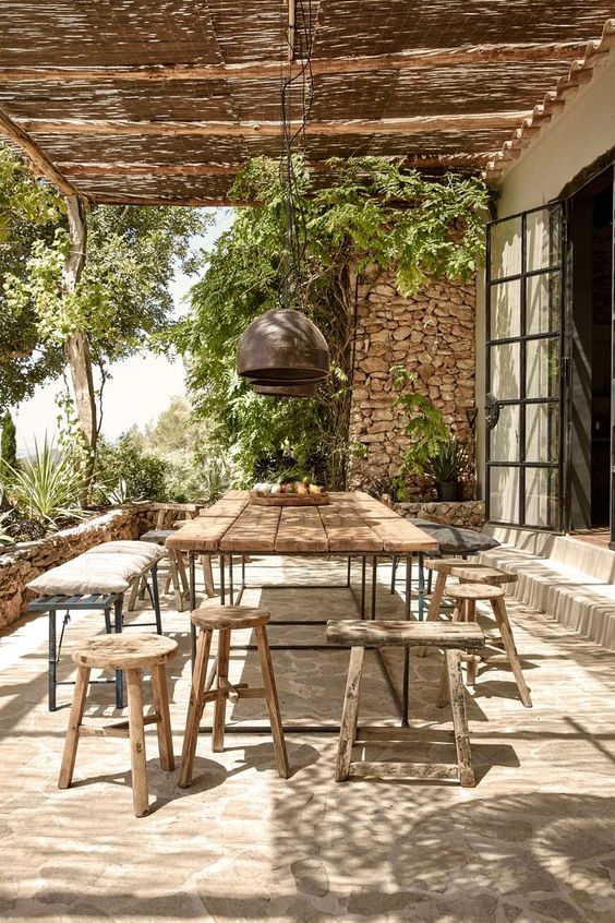 Mediterranean-inspired dining space with a rustic dining set for a warm look