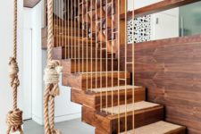 20 a wooden and rope swing can be an accent in the interior, like here it echoes with the stairs