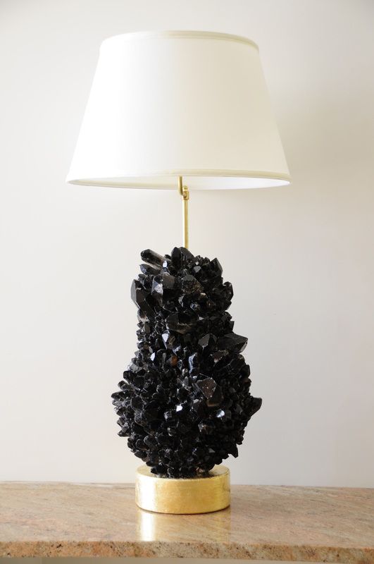 a black geode and gilded base lamp with a neutral lampshade for a glam feel