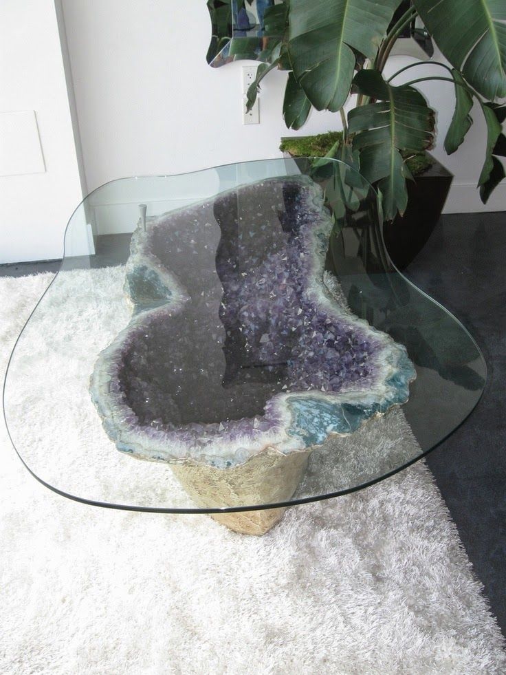 A jaw dropping coffee table with an amethyst geode base and a glass top will be a showstopper