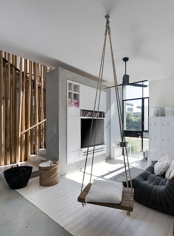 modern industrial living space with a cozy rustic swing as a storage unit