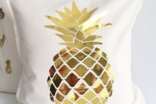 23 a cream pillow case with a gold pineapple