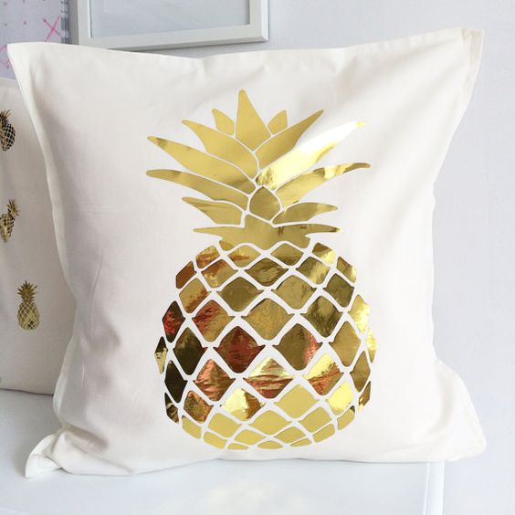 a cream pillow case with a gold pineapple