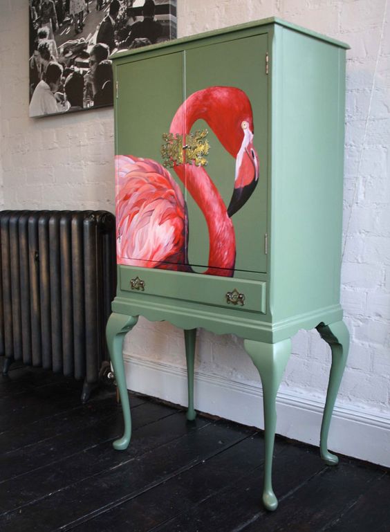 a vintage-inspired green chest of drawers with a bold flamingo