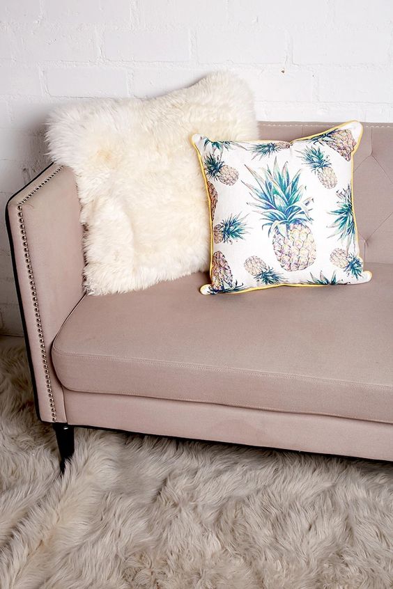 a woven pillow featuring an allover pineapple print, a contrast trim