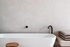 24 white concrete walls and light-colored terrazzo floors for a calming bathroom look