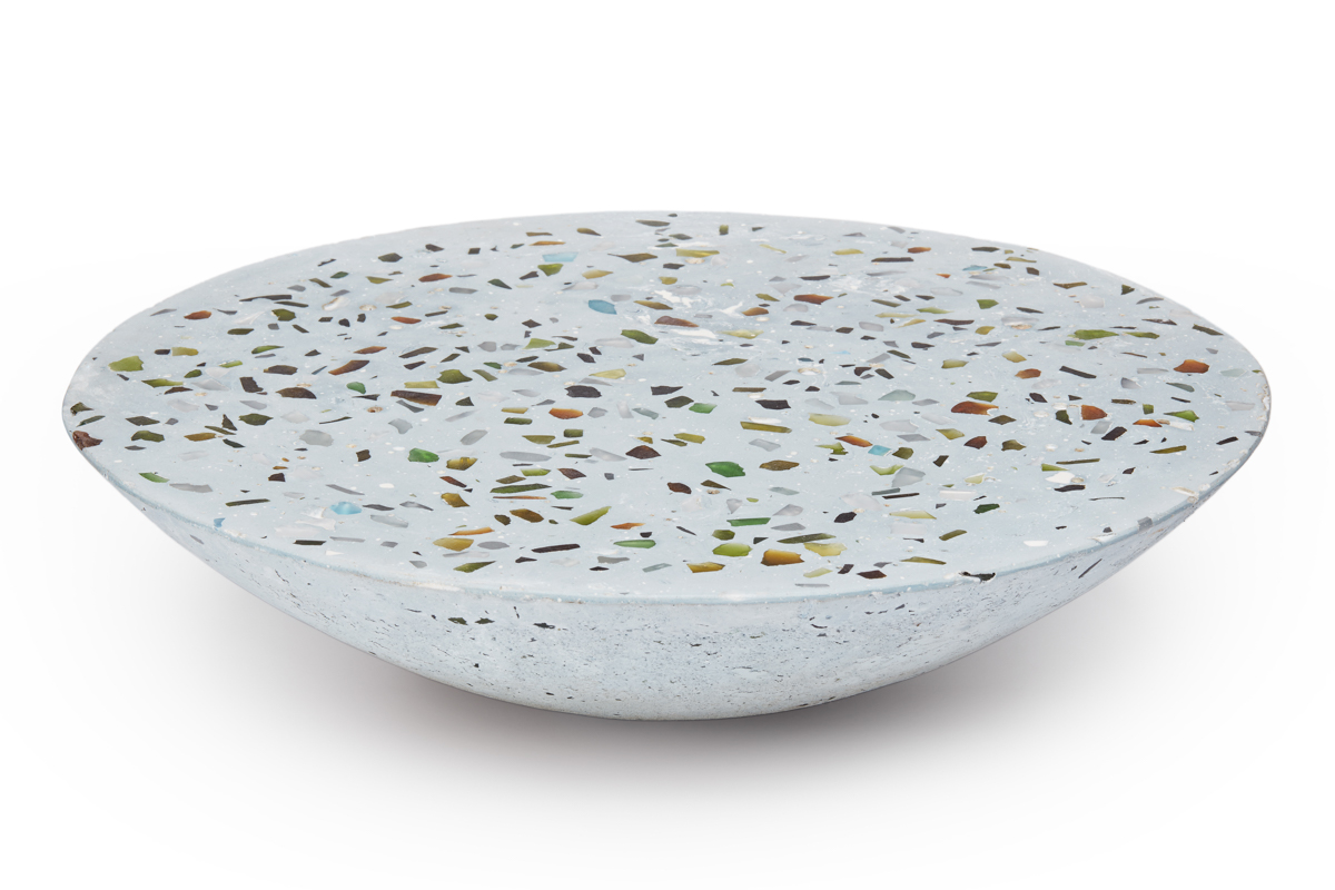 A bowl shaped terrazzo coffee table with colorful inserts is amazing both for indoors and outdoors