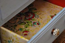27 colorful floral wallpaper inside the drawers and on the sides for a bold look