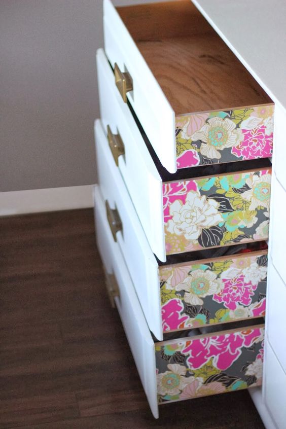 colorful floral wallpaper on the drawers' sides to add a chic touch
