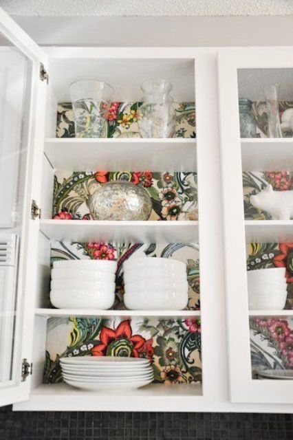 Retro inspired wallpaper inside a glass kitchen cabinet for a bold look