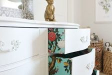 31 turquoise floral wallpaper lining the drawers of a vintage dresser