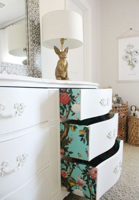turquoise floral wallpaper lining the drawers of a vintage dresser