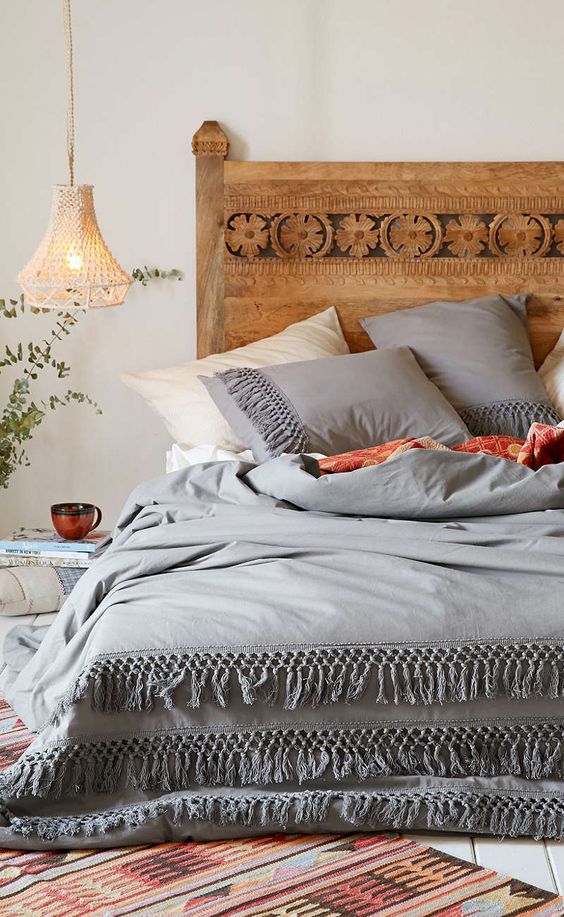 grey and ivory bedding with tassel rows look boho yet very calming