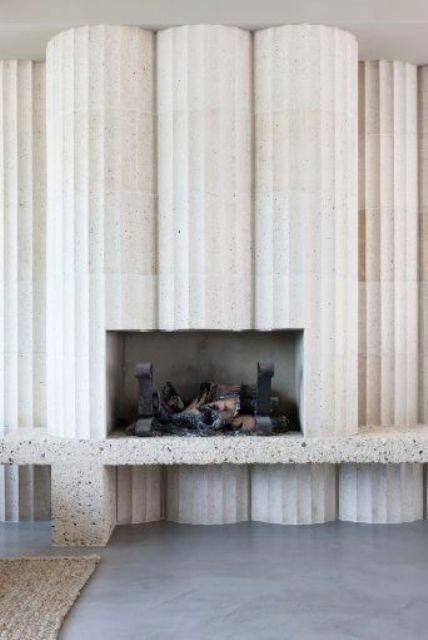 white terrazzo columns with a fireplace inside look unique