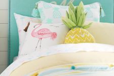 28 a pink flamingo pillow, a pineapple pillow and colorful pompom bedding