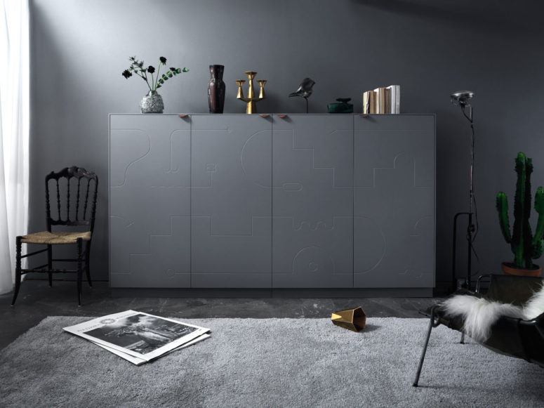 Matte grey sideboard from Delirium collection with brown leather handles on top and carved patterns