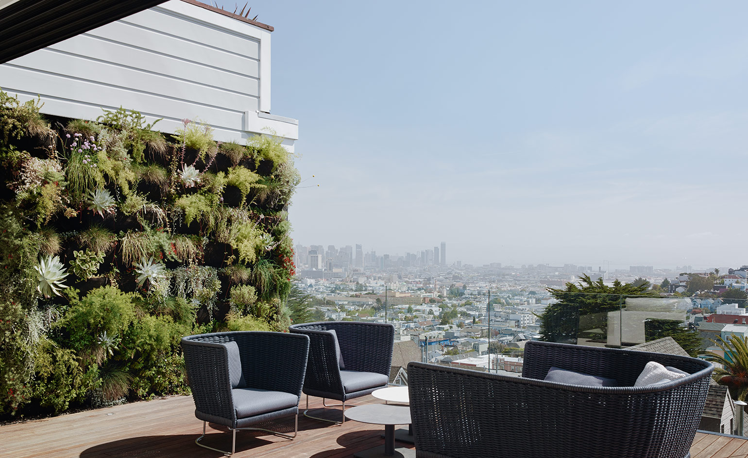 A terrace with a lush living wall overlooks San Francisco