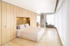 02 Most of the apartment is clad with light-colored wood, which adds warmth and hides storage spaces