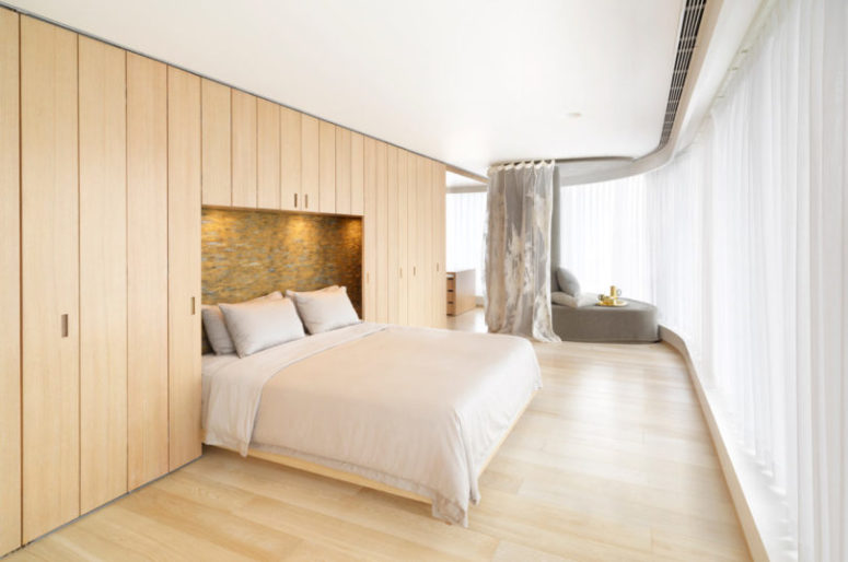 Most of the apartment is clad with light-colored wood, which adds warmth and hides storage spaces