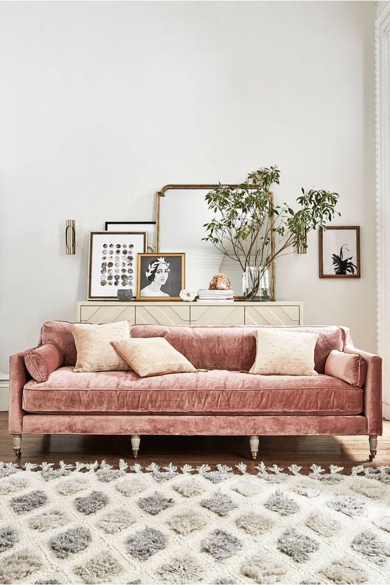 a blush velvet sofa will enliven a neutral living room and make it more feminine