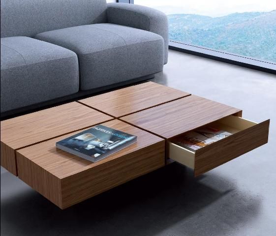 a coffee table that features four drawers for storage and a cool laconic look