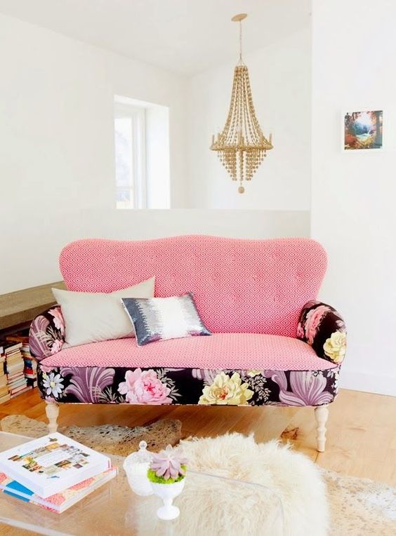a loveseat with mixed upholstery in geo pink and large blooms in the black backdrop adds a glam touch