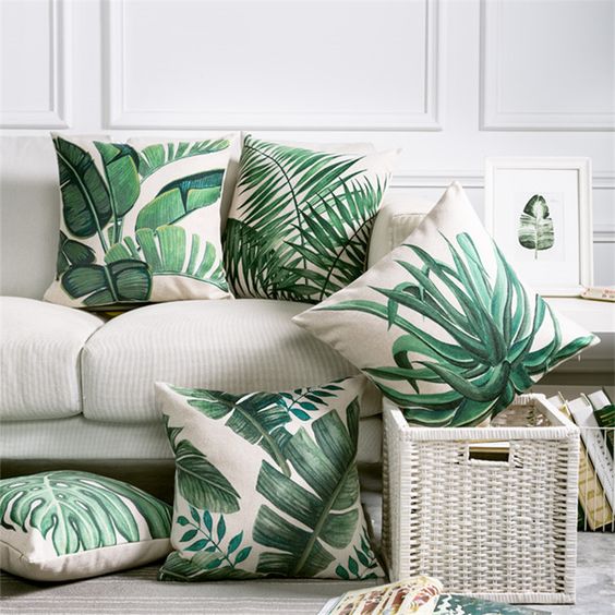 a selection of torpical leaf print pillows is a budget-savvy way to brighten up the space