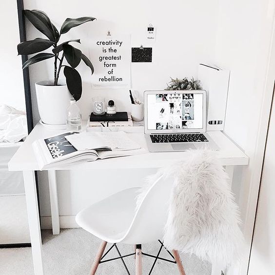 This white Nordic home office was made more interesting with a faux fur chair