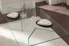 02 ultra-minimalist dining table with geo glass legs and a glass tabletop, the dishes seem to be floating in the air