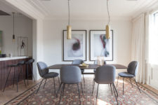 03 The dining zone united with the living room is defined with two modern brass pendant lamps