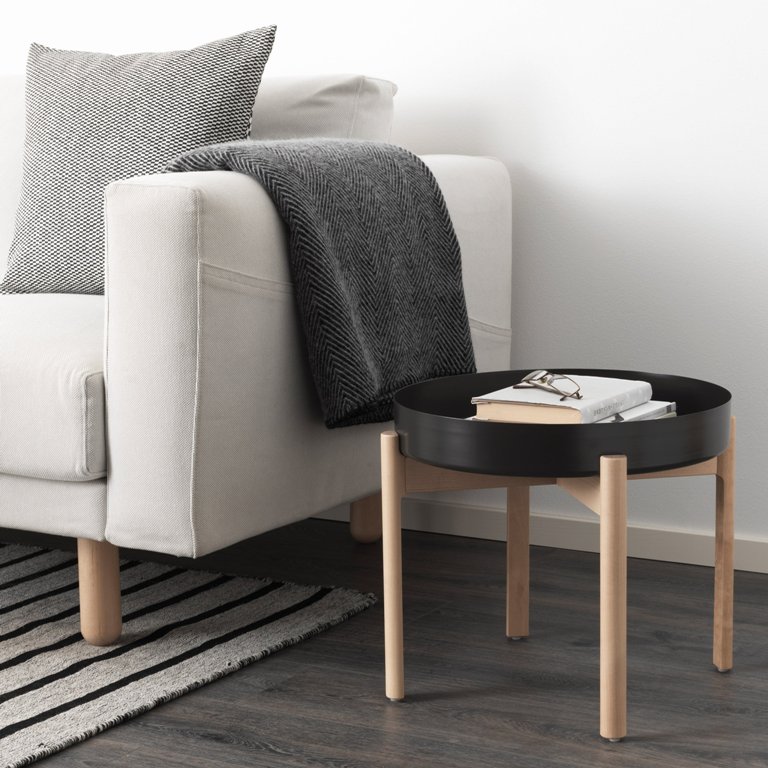 These are two key pieces of Ypperlig collection, a sofa and a wooden stand side table