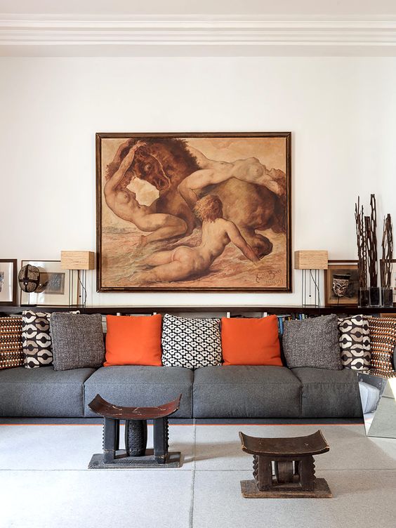 This is the second living room with an oversized grey sofa, Asia-inspired artworks and furniture and a bold piece of art that makes a statement