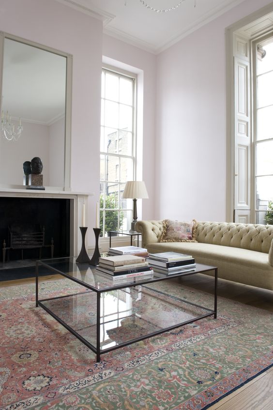 a black framed glass coffee table makes this vintage living room more modern