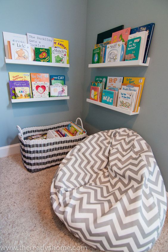 a cozy reading space with a bean bag chair, bookshelves and a basket to encourage reading