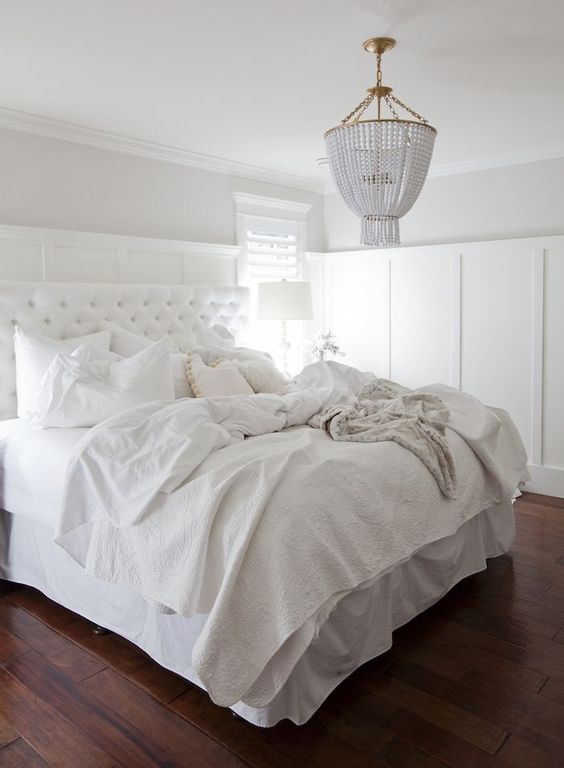 a textural bedspread and a diamond upholstery headboard add eye-catchiness to this light-filled bedroom