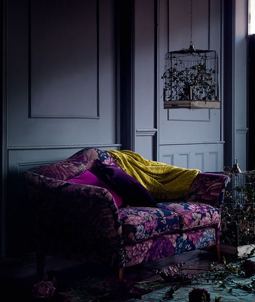 if your space is moody and dark, why not go for a deep purple and blue loveseat that fits the style