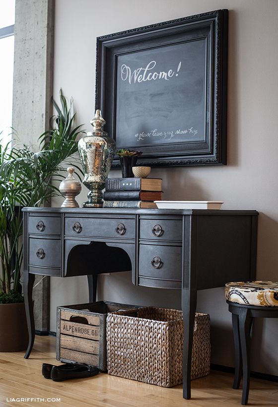 A black desk turned into a console wil easily fit a rustic or vintage inspired interior
