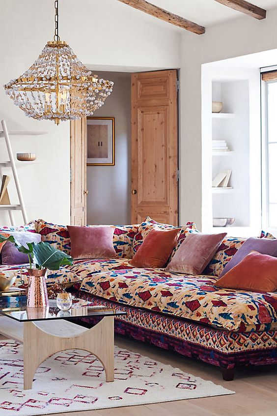 a colorful sectional sofa with bold velvet pillows for a lively boho chic space