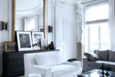 04 an antique French framed mirror adds chic and beauty to this living room