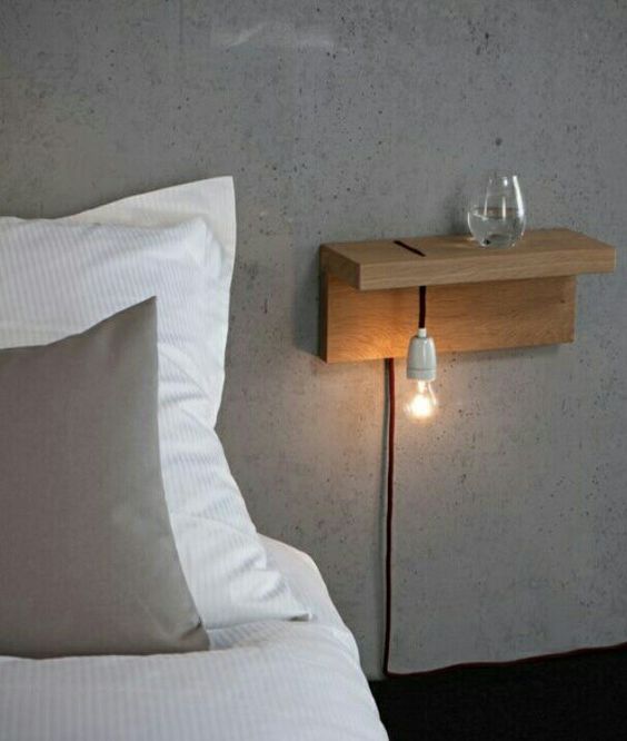 attach a piece of wood to the wall and add a bulb - and voila, an industrial nightstand is ready