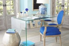 04 sea-inspired home office with a glass desk and touches of blue looks vivacious