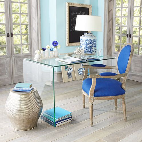 sea-inspired home office with a glass desk and touches of blue looks vivacious