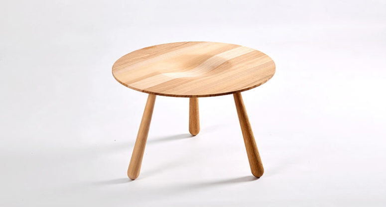 A wooden coffee table with a texture and a curved tabletop