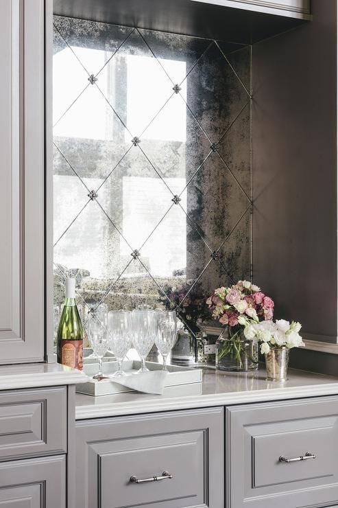an antique mirror bar backsplash fits grey and white cabinets perfectly