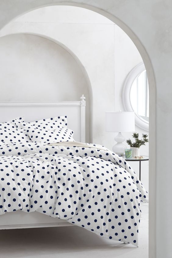 white and navy polka dot bedding for a girl's space