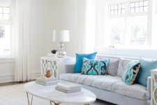 07 The living room is neutral, with blue pillows and eclectic furniture