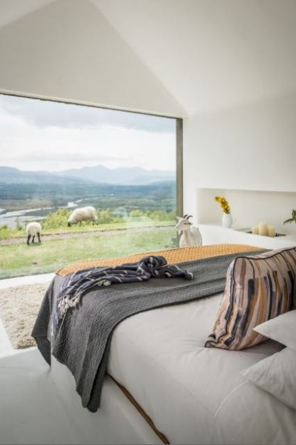 The master bedroom features a panoramic window with amazing and relaxing views including lake views