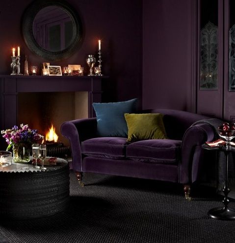 a deep purple velvet sofa for a moody space in purple