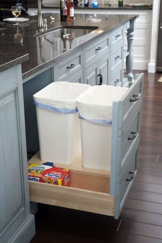 a pull out drawer with trash cans is a comfy solution that works for any kitchen