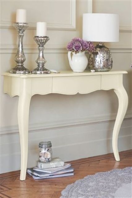 an antique desk was cut and repainted to use it as a small console table for a tight vintage space